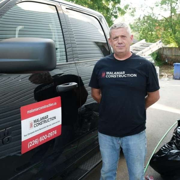 Dave Cuthbert, Co-Owner and Project Manager, beside the Malamar van