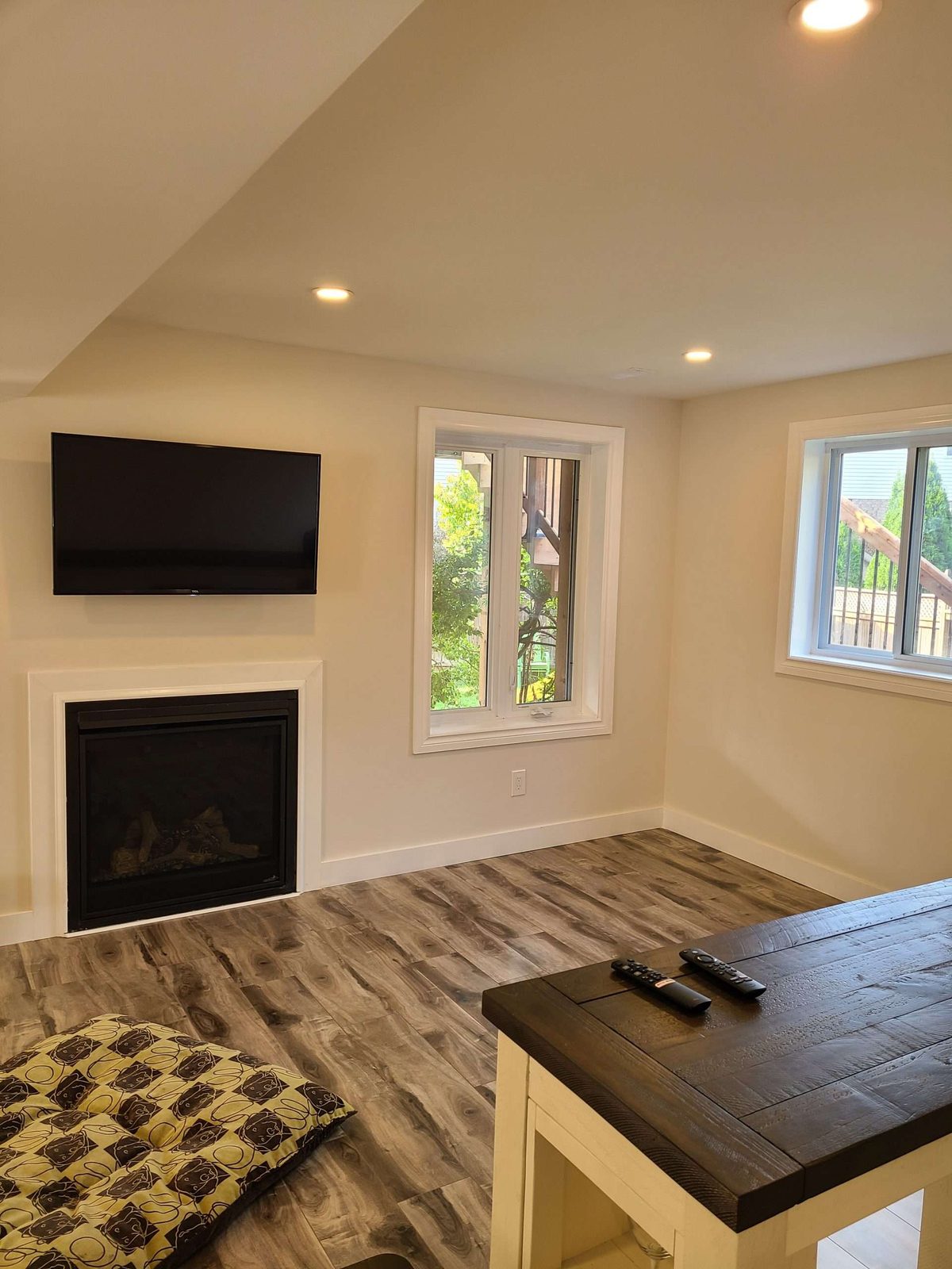Living room with a fireplace, TV and patterned tile
