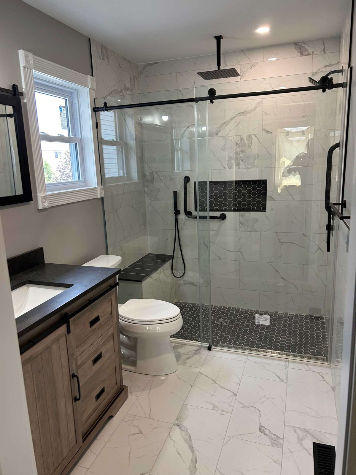 Glass shower and marble bathroom